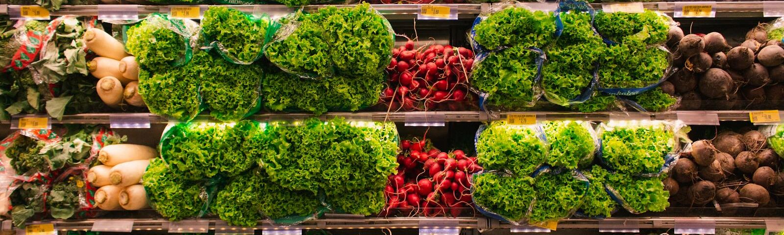 Colorful assortment of fresh vegetables arranged on supermarket shelves, perfect for healthy eating themes.