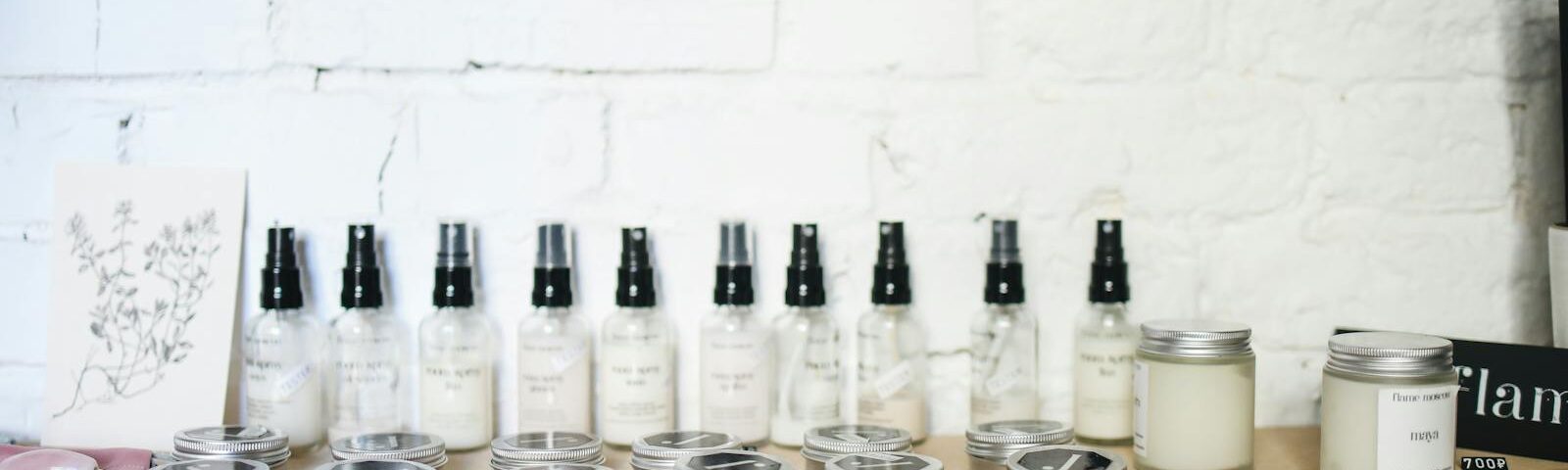 Minimalist skincare products displayed on a wooden shelf against a white brick wall.